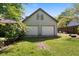 Detached garage features a light gray siding, an upper level window, and a two-car garage entrance at 2921 Huntcliff Dr, Marietta, GA 30066