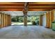 Open garage area with visible wooden beams, an open overhead door, and access to the outdoor space at 2921 Huntcliff Dr, Marietta, GA 30066