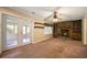 Spacious living room with a fireplace, built-in shelves, and access to a sunroom through glass doors at 2921 Huntcliff Dr, Marietta, GA 30066
