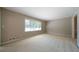 Bright living room featuring large windows and neutral carpeting at 2921 Huntcliff Dr, Marietta, GA 30066