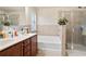 Bright bathroom with a soaking tub, shower, double sink vanity, and tile accents at 3229 Hallmark Ln, Buford, GA 30519