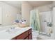 Bright bathroom featuring a shower-tub combination, a sink, and decorative details at 3229 Hallmark Ln, Buford, GA 30519