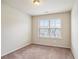 Empty bedroom with a carpet floor and a window with neighborhood views at 3229 Hallmark Ln, Buford, GA 30519