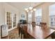 Charming dining room with a wooden table, decorative chandelier, and natural light at 3229 Hallmark Ln, Buford, GA 30519
