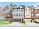 Well-manicured townhome showcasing a welcoming two-car garage and detailed architectural design at 3229 Hallmark Ln, Buford, GA 30519