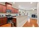 Open kitchen with stainless appliances, granite counters, connecting to the living area at 3229 Hallmark Ln, Buford, GA 30519