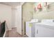 Convenient laundry area with washer and dryer, and shelving for storage at 3229 Hallmark Ln, Buford, GA 30519