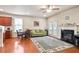 Open-concept living area showcasing a fireplace, hardwood floors, and natural light at 3229 Hallmark Ln, Buford, GA 30519