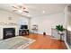 Bright living room boasts a cozy fireplace, hardwood floors, and a staircase at 3229 Hallmark Ln, Buford, GA 30519