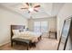 Main bedroom with a tray ceiling, carpeted floor, and a comfortable bed at 3229 Hallmark Ln, Buford, GA 30519