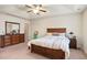 Comfortable main bedroom with carpet flooring, a tray ceiling, and wood furniture at 3229 Hallmark Ln, Buford, GA 30519