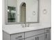 Bright bathroom with a gray vanity with a white countertop and framed mirror at 520 Tackett Farms Rd, Smyrna, GA 30082