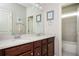 Traditional bathroom featuring a double vanity, framed mirrors, and neutral paint at 520 Tackett Farms Rd, Smyrna, GA 30082