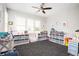 Bright bedroom with neutral carpet, large window, ceiling fan, and built-in storage at 520 Tackett Farms Rd, Smyrna, GA 30082