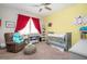 Cozy Bedroom featuring a recliner, crib, and playful decor with red accents at 520 Tackett Farms Rd, Smyrna, GA 30082