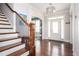 Elegant foyer showcases hardwood floors, staircase, and a decorative chandelier at 520 Tackett Farms Rd, Smyrna, GA 30082
