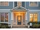 Close-up of home's front door with sidelights, decorative plants, manicured shrubbery and address numbers at 520 Tackett Farms Rd, Smyrna, GA 30082