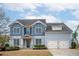 Charming two-story home with a well-manicured lawn, a two-car garage and a welcoming front porch at 520 Tackett Farms Rd, Smyrna, GA 30082