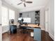 Bright home office with custom built-ins, hardwood floors, ceiling fan and a view to the outdoors at 520 Tackett Farms Rd, Smyrna, GA 30082