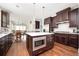 Spacious kitchen boasts dark wood cabinets, stainless steel appliances, and a center island at 520 Tackett Farms Rd, Smyrna, GA 30082