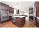 Modern kitchen with stainless steel appliances, a center island, and dark wood cabinets at 520 Tackett Farms Rd, Smyrna, GA 30082