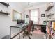 Bright home office with a modern desk, plush chair, and ample shelving at 520 Tackett Farms Rd, Smyrna, GA 30082