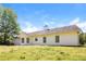 Rear exterior of home with bright siding, manicured yard and lush greenery at 265 Mountainview Dr, Covington, GA 30016