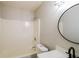 Bright bathroom featuring modern fixtures, a tub-shower combo and a round mirror at 265 Mountainview Dr, Covington, GA 30016