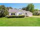 View of a well-maintained home featuring a lush lawn, and manicured landscaping at 265 Mountainview Dr, Covington, GA 30016