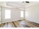 Spacious main bedroom featuring tray ceiling and new wood flooring at 265 Mountainview Dr, Covington, GA 30016