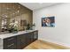 Modern bar area with a wine fridge, storage cabinets, and a beautiful tiled wall at 1906 Variations Ne Dr, Atlanta, GA 30329