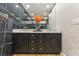 Bathroom vanity with black marble accent wall, double sinks, elegant lighting, and modern fixtures at 1906 Variations Ne Dr, Atlanta, GA 30329