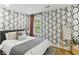 Cozy bedroom with geometric wallpaper, comfortable bed, and stylish decor at 1906 Variations Ne Dr, Atlanta, GA 30329
