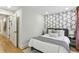 Stylishly designed bedroom features accent wall and neutral color scheme at 1906 Variations Ne Dr, Atlanta, GA 30329
