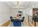 Bright dining room with modern chandelier and wall decor. View to kitchen at 1906 Variations Ne Dr, Atlanta, GA 30329
