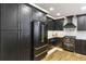 Sleek kitchen with dark cabinets, stainless steel appliances, and warm wood floors at 1906 Variations Ne Dr, Atlanta, GA 30329