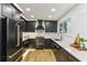 A modern kitchen featuring dark cabinets, stainless steel appliances, and bright countertops at 1906 Variations Ne Dr, Atlanta, GA 30329