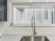 Close-up of a kitchen sink with marble countertop and a modern faucet at 1906 Variations Ne Dr, Atlanta, GA 30329
