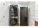 Modern laundry area features stacked washer and dryer, plus storage cabinet at 1906 Variations Ne Dr, Atlanta, GA 30329