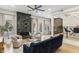 Bright living room with a fireplace, modern ceiling fan, and beautiful hardwood flooring at 1906 Variations Ne Dr, Atlanta, GA 30329