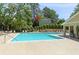 Community pool area with lounge chairs and mature trees at 1906 Variations Ne Dr, Atlanta, GA 30329