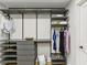 Walk-in closet with custom shelving, gray built-ins, and ample storage for clothes and accessories at 1906 Variations Ne Dr, Atlanta, GA 30329