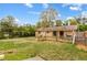 Expansive backyard with a wooden fence, patio, and lush green lawn on a sunny day at 338 Patricia Sw Ave, Marietta, GA 30060
