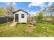 View of a versatile backyard with a white storage shed, a dog house, and a convenient ramp at 338 Patricia Sw Ave, Marietta, GA 30060