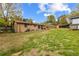 Large backyard featuring a patio and a spacious lawn with trees under a sunny, partly cloudy sky at 338 Patricia Sw Ave, Marietta, GA 30060