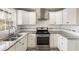 Bright kitchen with granite countertops, stainless steel appliances, and sleek white cabinets at 338 Patricia Sw Ave, Marietta, GA 30060
