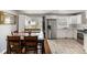 Bright kitchen with stainless appliances, granite counters, wood floors, and an adjacent dining area at 338 Patricia Sw Ave, Marietta, GA 30060
