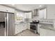Bright kitchen featuring stainless steel appliances, granite countertops, and subway tile backsplash at 338 Patricia Sw Ave, Marietta, GA 30060