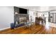 Open-concept living space with hardwood floors, modern fireplace, and kitchen dining area at 338 Patricia Sw Ave, Marietta, GA 30060