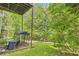 View of the backyard features an area with lush trees and greenery, and an exterior staircase from a deck at 7450 Chads Cir, Jonesboro, GA 30236